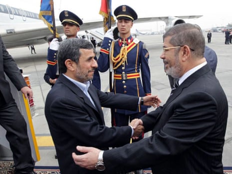 Egyptian president Mohamed Morsi greets Mahmoud Ahmadinejad at Cairo airport. It was the first visit by an Iranian head of state to Egypt in more than 30 years.