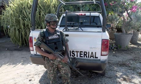 A Mexican marine stands guard outside the property in Acapulco 