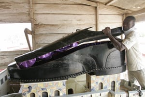 Coffins in Ghana: An undertaker opens a coffin, shaped like a shoe, in his showroom, Accra