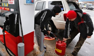 A man fills up a gas tank at a fueling station in the Queens borough of New York on Friday.