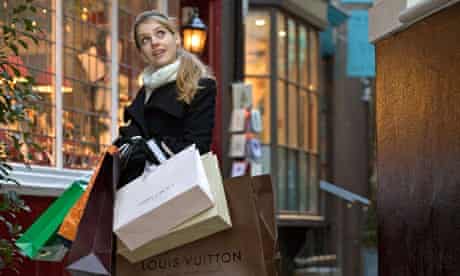 A young woman loaded with expensive shopping bags in London's West End