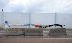 The clothes of refugees hang out to dry on a wall at a refugee camp in Bab al-Salam on the Syria-Turkey border on Thursday.