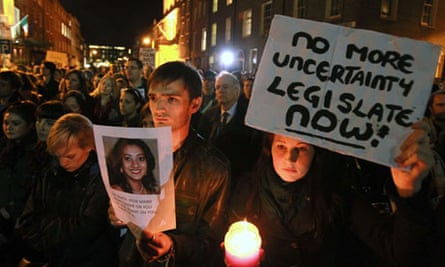 Protestors hold pictures of Savita Halappanavar who died after an Irish hospital refused an abortion