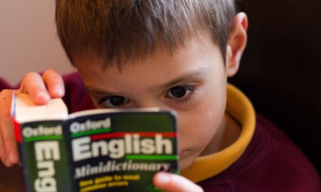 Child reading an English Dictionary in School uniform