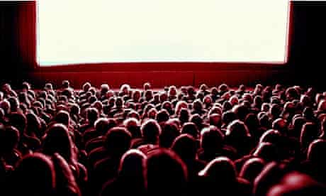 Crowd watching movie in theatre