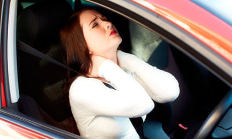 Girl massaging neck in a car
