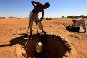 Water in Sudan: a man pulls drinking water from a well in El-Halaba