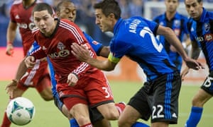 Montreal Impact's Davy Arnaud, right, takes on Toronto FC's Hogan Ephraim