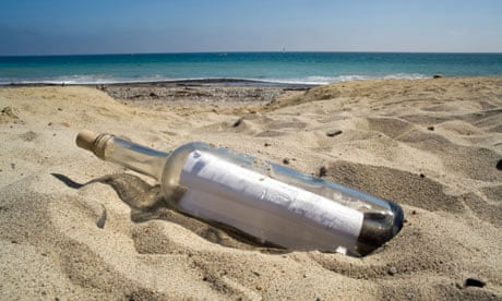 A bottle containing a message lies on a beach at sunset.. Image shot 2009. Exact date unknown.