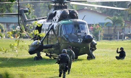Malaysian commandos board a helicopter for the assault against Filipino gunmen in Borneo