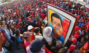 Supporters of Venezuela's late President Hugo Chavez wait for a chance to view his body at the military academy in Caracas where Chavez will be embalmed and put on display after a state funeral.