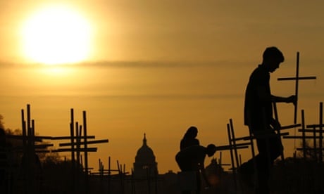 The sun rises above the US Capitol as volunteers place crosses, symbolising grave markers, on the National Mall in Washington. A 24-hour vigil is being held featuring a gathering of Newtown clergy and 3,300 grave markers to 'remind Congress action is needed on gun violence prevention'. The number 3,300 represents the supposed number of people who have died as a result of gun violence since the tragedy at the school in Newtown, Connecticut.