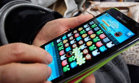 A commuter playing a game on a smartphone