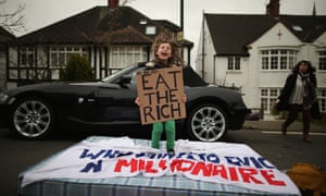 Eight-year-old Lucien Shalmy-Freeman bounces on a mattress as UK Uncut supporters protest over the government's changes to the welfare system and the proposed 'Bedroom Tax' in London. The anti-austerity campaigners gathered outside the Highgate home of Lord Freud during a day of action, after they promised to target the home of a "well-known millionaire".