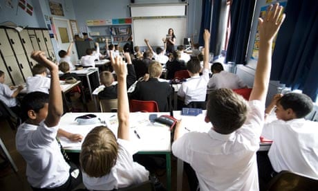 GCSE-age children put up their hands in class