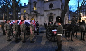 Bearer Party from the three military services place a coffin on a Gun Carriage of the King's Troop Royal Horse Artillery outside St Clement Danes church during the dress rehearsal.