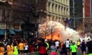 In this image from video provided by WBZ TV, spectators and runners run from what was described as twin explosions that shook the finish line of the Boston marathon.
