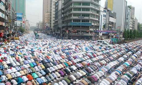 Muslim men pray in the street in Dhaka