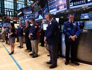 Traders observe a moment of silence to honor the victims and families of the Boston Marathon bombings, before the opening bell on the floor of the New York Stock Exchange, April 16, 2013.