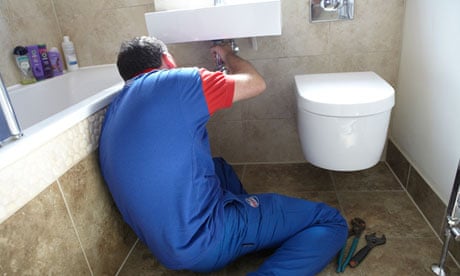 A plumber fixes a bathroom sink