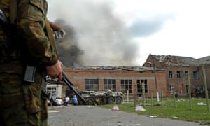 Soldiers and security forces are seen in front of a burning school in Beslan, nortern Ossetia, 03 September 2004