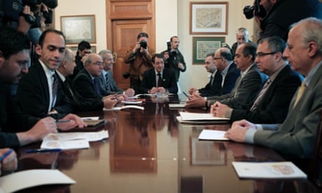 Cyprus' new finance minister Haris Georgiades, second from left, in a meeting ahead of the country's bailout.