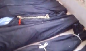 An image grab from an activists' video shows covered bodies of Syrians found dead in the town of Jdaidet al-Fadel, outside Damascus.