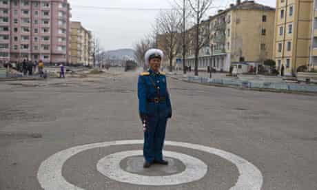 A North Korean traffic policeman stands at an intersection in Kaesong