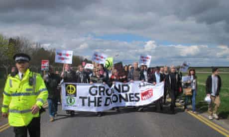Protesters march to the perimeter fence of RAF Waddington, Lincolnshire
