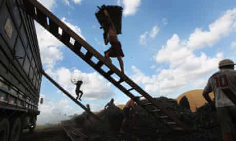 a worker carrying illegally sourced charcoal from the Amazon