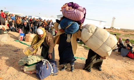 Egyptians wait  for transportation at the Libyan and Tunisian border crossing of Ras Jdir