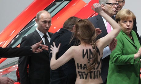 Russian president Vladimir Putin, left, is accosted by a Femen activist in Hanover