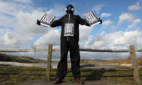 A masked man protesting against fracking