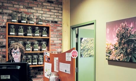 A Denver Relief’s ‘budtender’ rings up a sale 