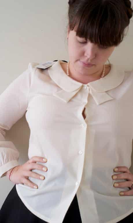Woman wearing a shirt with buttons gaping open over the bust