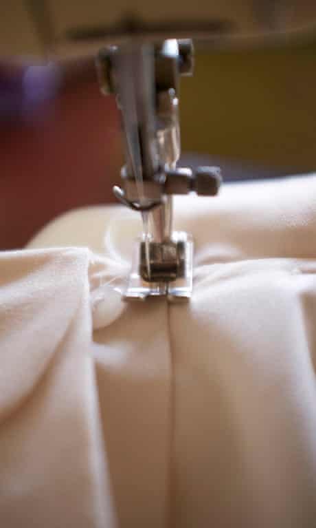 Image of a a button-down blouse on a sewing machine