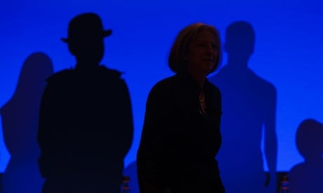 The shadowy figure of home secretary Theresa May, walks on stage before making a speech to the Police Federation of England and Wales annual conference in Bournemouth, Dorset.