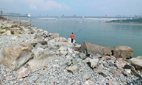 A man fishes near the Three Gorges dam, the world's most powerful hydroelectric project