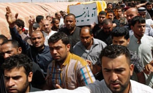 Iraqis carry the coffin of one of the two Iraqi Shiites killed fighting in neighbouring Syria alongside Presidential forces. Their bodies arrived in the southern Iraqi city of Basra this morning. Tribal chiefs, local officials, and police and army officers were present when the bodies in coffins wrapped in Iraqi flags arrived, after being brought via Iran.