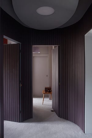 homes - bristol house: hallway with grey carpet and brown curved walls
