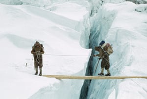 everest: Everest sherpas in crampons cross log bridge, Western Cwm