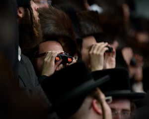 Jewish Wedding: Jews of the Belz Hasidic Dynasty use binoculars to watch the wedding