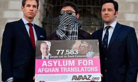 An Afghan interpreter with former British servicemen delivering a petition calling for asylum