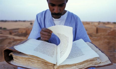 Curator Reading Koran on Roof of Library, Mauritania