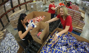 Volunteers fill boxes with nonperishables food items at the Feed the Children distribution centre in Oklahoma City to help tornado victims.
