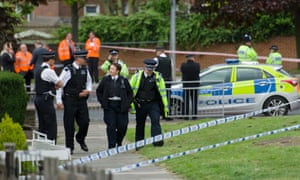 Police officers man a cordoned off area in Woolwich, east London following an incident in which a man was killed and two others seriously injured.
