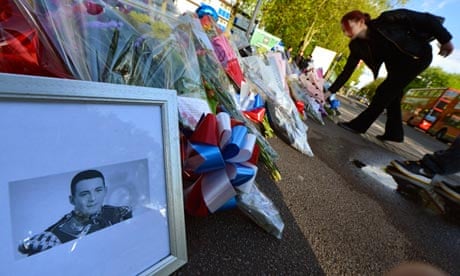 A picture of Drummer Lee Rigby is displayed with flowers outside an army barracks in Woolwich