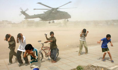Iraqi children take cover from sand in Basra 2