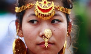 A woman wearing traditional dress participates in a parade marking the 60th anniversary today of Sir Edmund Hillary and Tenzing Norgay Sherpa's conquest of Mount Everest, in Kathmandu, Napal.