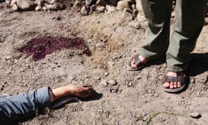 An Afghan man stands near the body of a suicide attacker killed by security personnel in Panjshir province. Taliban suicide bombers, some dressed as police, killed a policeman in a rare attack on the governor's compound in Afghanistan's anti-Taliban Panjshir valley.